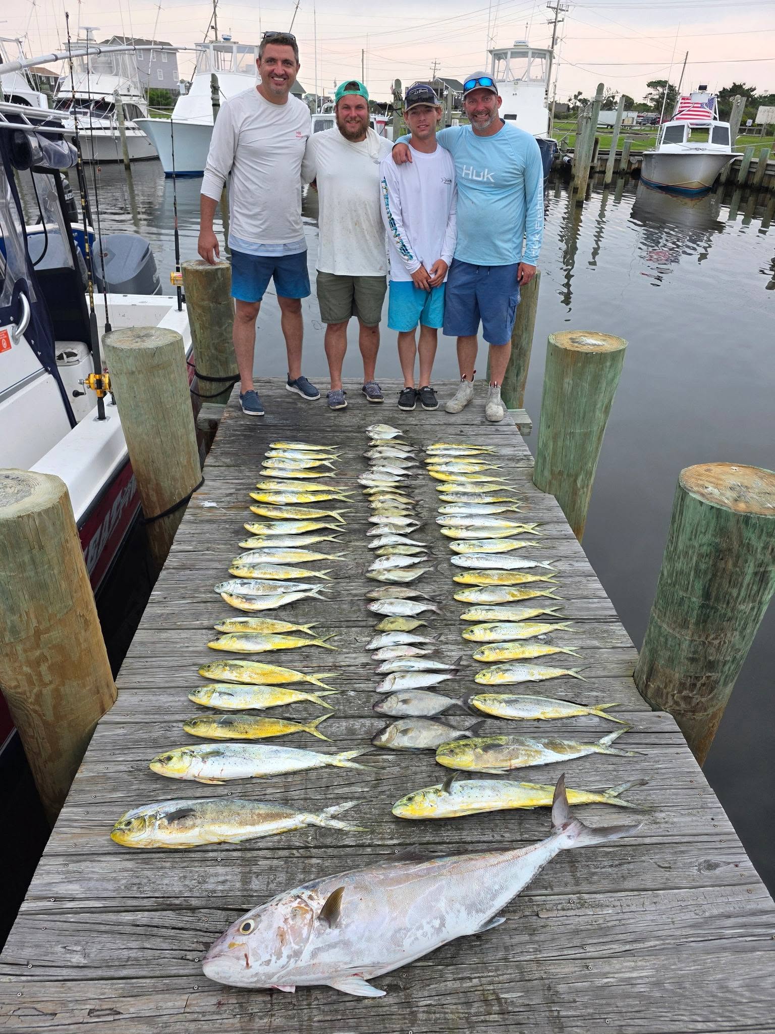Captain Jake Hiles with anglers and mahi-mahi caught during a summer offshore fishing charter out of Hatteras, NC aboard Matador Charters.